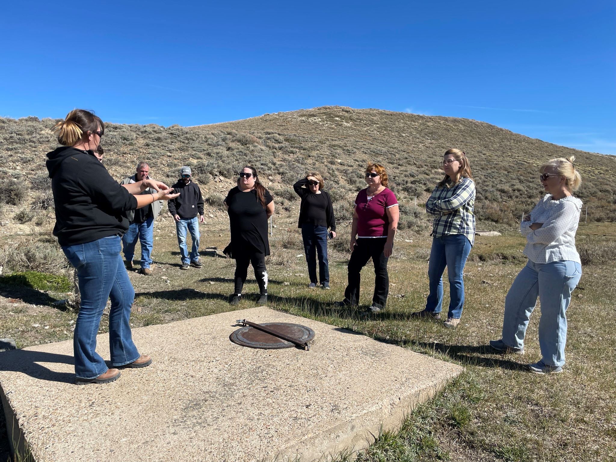 City staff tour Sage Creek Basin in October 2021, seen here standing near the top of a spring box